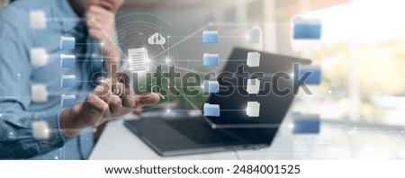 A person using a laptop to manage digital documents, highlighting the concept of document management and organization in the digital era.