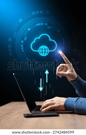 Person using laptop to upload data to cloud storage in digital workspace