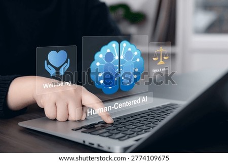 Person using laptop with virtual human-centered AI interface showing well-being, ethics and values, and responsible technology concepts. Digital ethics concept for trustworthy artificial intelligence, human oversight, inclusive design, social responsibility, and value-driven innovation in a modern workspace.