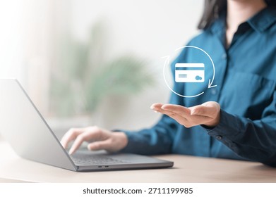 A person using a laptop while displaying a virtual credit card icon, representing online card replacement and secure digital banking services. Request new card after damage.