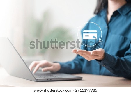 A person using a laptop while displaying a virtual credit card icon, representing online card replacement and secure digital banking services. Request new card after damage.