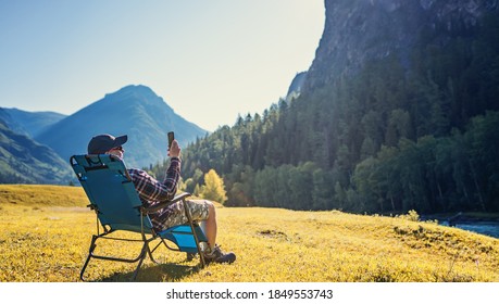 person using mobile phone in the wild - Powered by Shutterstock