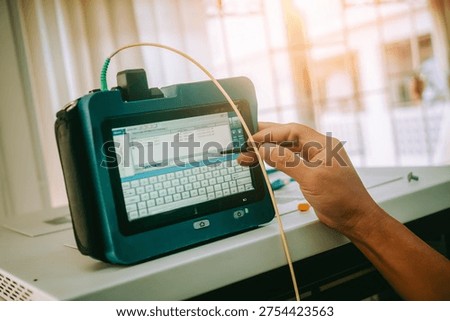 A person using a modern tablet device in an office setting, demonstrating data input and analysis with a focus on technology and productivity.