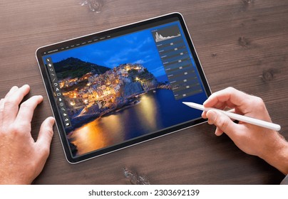 Person using photo editor on digital tablet