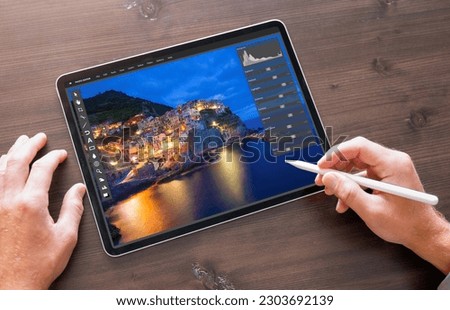 Person using photo editor on digital tablet