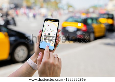 Person using ride sharing app on mobile phone