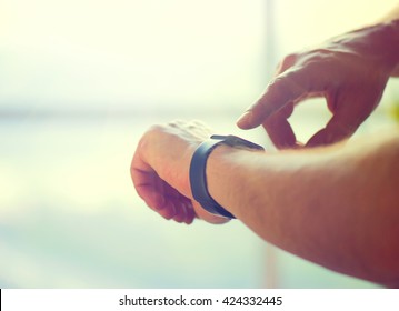 Person Using Smart Watch. Young Man Making Gestures On A Wearable Smart Watch Computer Device, Smartwatch Close Up (unrecognizable)