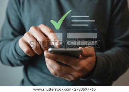 Person using a smartphone to complete a digital form with a checkmark confirmation