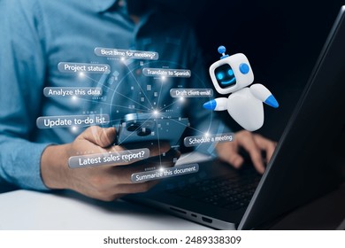 A person using a smartphone to interact with an AI assistant displayed as a friendly robot and chat bubbles. The background shows a laptop indicating multitasking and technology use. - Powered by Shutterstock