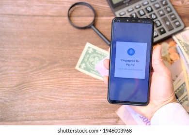 Person Using Smartphone And Using Paypal Application On 30 March 2021