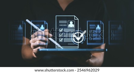 Person using a stylus on a tablet to interact with holographic resume documents. Dark background. Concept of digital job application process
