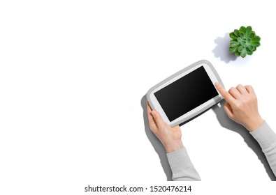 Person using a tablet computer from above