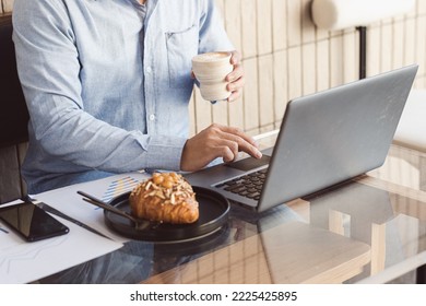 a person is using a tablet with a cup of coffee.
