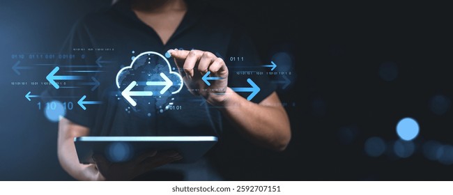 Person using a tablet with digital cloud storage and data transfer arrows on a dark background. Concept of online network system and remote access