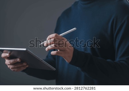 Person using tablet and digital pen representing modern technology, online learning, digital creativity, remote work, business productivity, graphic design, and smart device concepts.