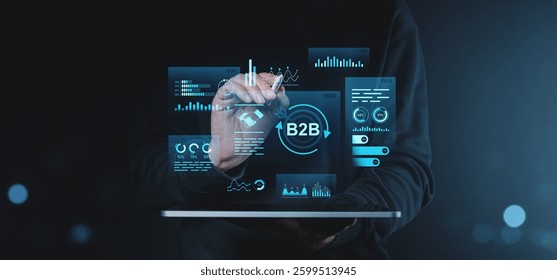 Person using a tablet with a holographic B2B interface, displaying data and analytics, on a dark background. Concept of business technology and marketing