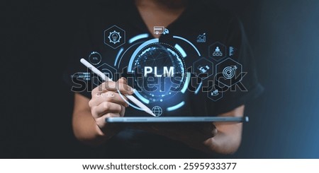 Person using tablet showing PLM interface in futuristic style on dark background. Concept of product lifecycle management