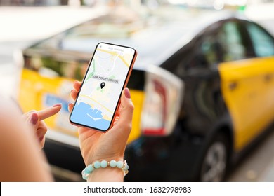 Person using taxi app on mobile phone