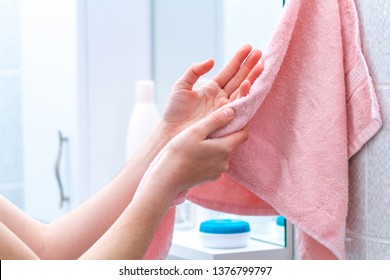 Person Using Towel For Wiping Hands Dry After Washing In Bathroom At Home. Hygiene And Hand Care 