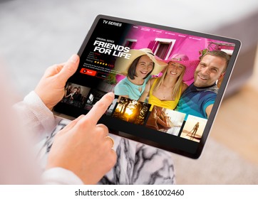 Person Using Video Streaming App On Tablet And Browsing Movies And TV Series To Watch