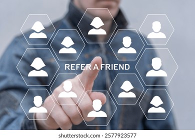 Person using virtual touchscreen push on text: REFER A FRIEND. Referral marketing or affiliate marketing concept. Invite friends to refer a friend loyalty program to win online reward. Refer and earn.