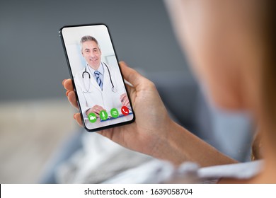 Person Videochatting With Doctor On Mobile Phone