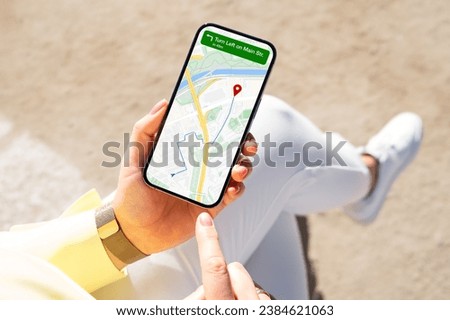Person viewing city map on mobile phone for navigation directions