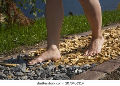 A Person Walking Barefoot On A Path With Different Surfaces