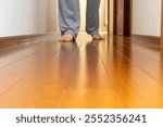 A person walking barefoot on a wooden walkway