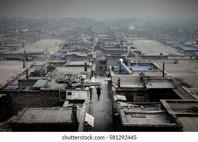 Person Walking With Dogs Surrounded By Coal Ash Pollution At Pingyao Ancient City, Shanxi, China. Photo Taken From The Wall.