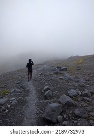 Person Walking Downhill Into Fog