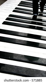 Person Walking On Piano Keys