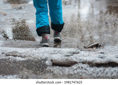 Person In Warm Shoes Standing On Wet Winter Road