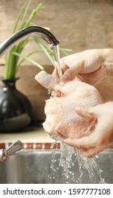 A Person Washing Raw Chicken 