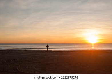 Person Watching Sunrise On The Beach