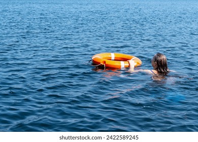 A person in the water gets a lifeline to help. The concept of saving drowning on the waterr, motion blur ..