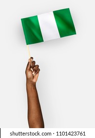 Person waving the flag of Federal Republic of Nigeria