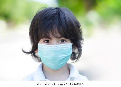 Person Wearing Facemask.Little Asian Boy Child With Face Mask.Stop Racism On Chinese.Respiratory Protection From Covid19 Or Corona Virus Influenza.