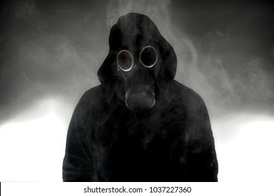 Person wearing gas mask surrounded by heavy smoke/fog/gas