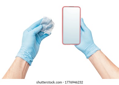 A Person Wearing Protective Medical Gloves Wipes His Mobile Phone With A Disinfectant, As One Of The Main Carriers Of Bacteria And Viruses. The Concept Of The Coronavirus Kovid-19 And OCD