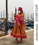 Person wearing venitian carnival mask during Venice carnival in Italy