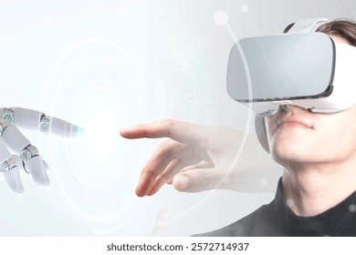 A person wearing VR goggles interacts with a robotic hand. Virtual reality and technology merge as human and robot connect in a futuristic setting. Banner image with blank copy space.