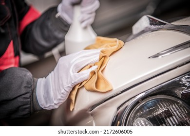 Person Wearing White Gloves Carefully Wipes The Surface Of A Vintage Cream-Colored Car With A Washcloth And A Dedicated Cleaning Fluid. Car Care And Maintenance Theme.