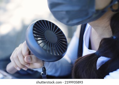 Person Who Cools Off With A Handy Fan