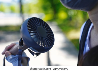 Person Who Cools Off With A Handy Fan