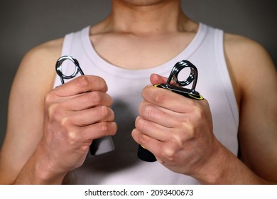 A Person Who Trains Grip Strength With A Hand Grip