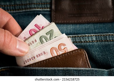 The Person Who Wants To Take The Wallet Full Of Money In His Jeans Pocket