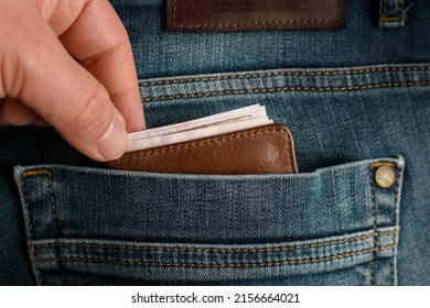 The Person Who Wants To Take The Wallet Full Of Money In His Jeans Pocket