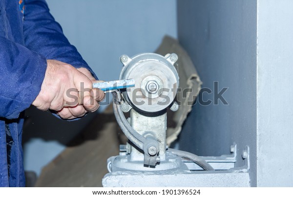 person working\
with electrical grinder in\
factory