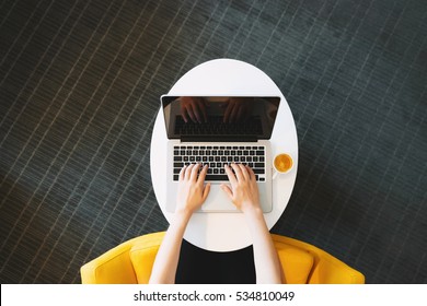 Person Working On A Laptop Computer In A Modern Room